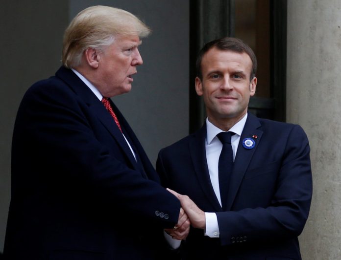 French President Emmanuel Macron shakes hands with U.S. President Donald Trump after a meeting at the Elysee Palace in Paris